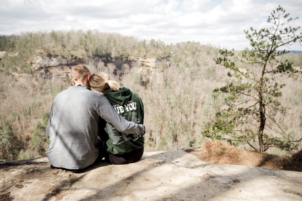 Scenic view of Sky Bridge in Red River Gorge with golden sunlight and lush greenery.