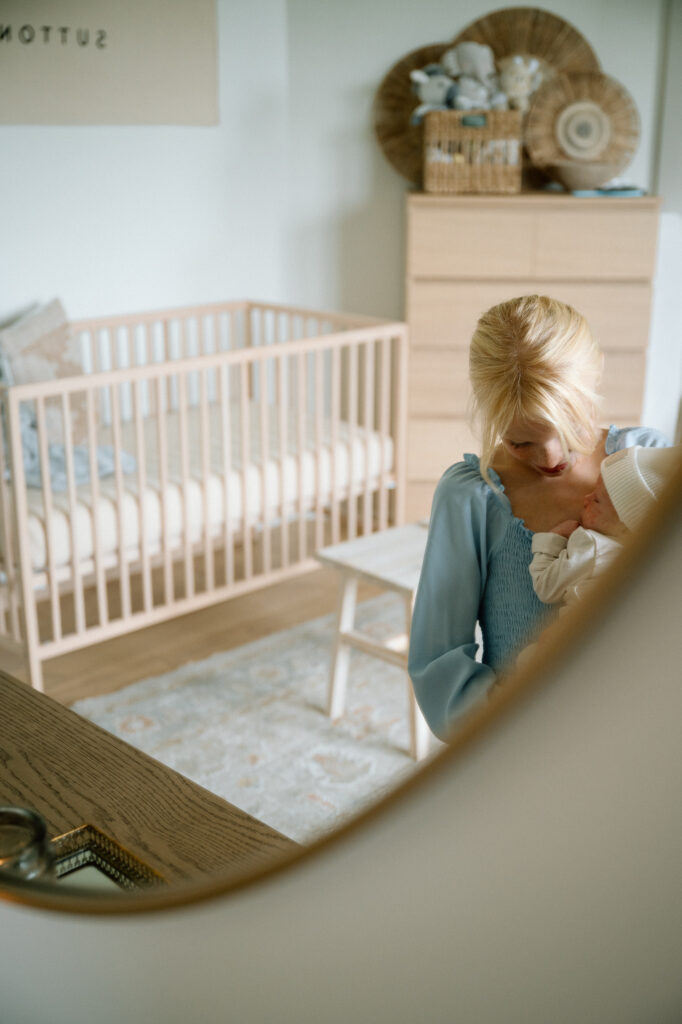 Big sister holding newborn baby lifestyle photo