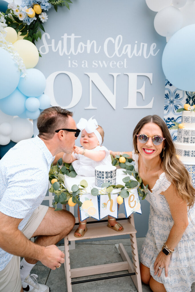 Candid family moment laughing with baby girl at outdoor lemon-themed shoot