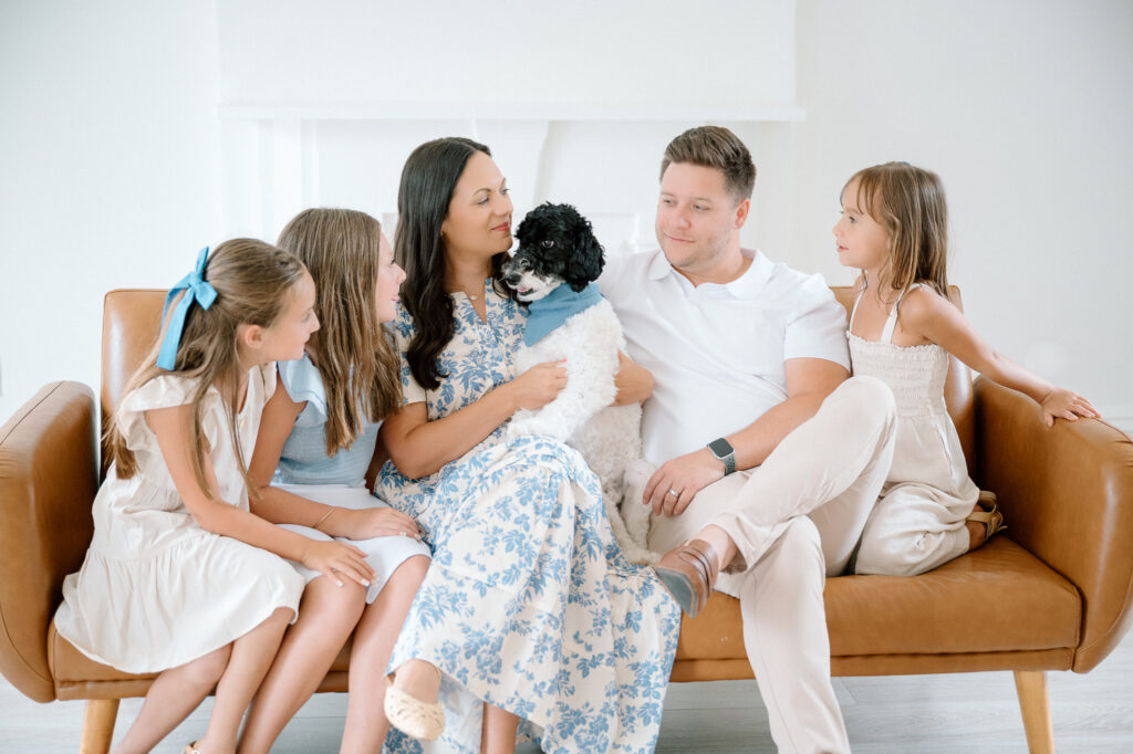 Dog sitting with family in professional portrait studio Lexington KY