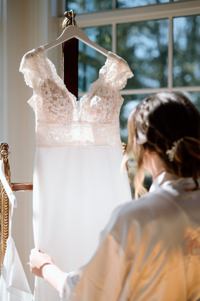 Bride looking at dress during wedding morning preparations