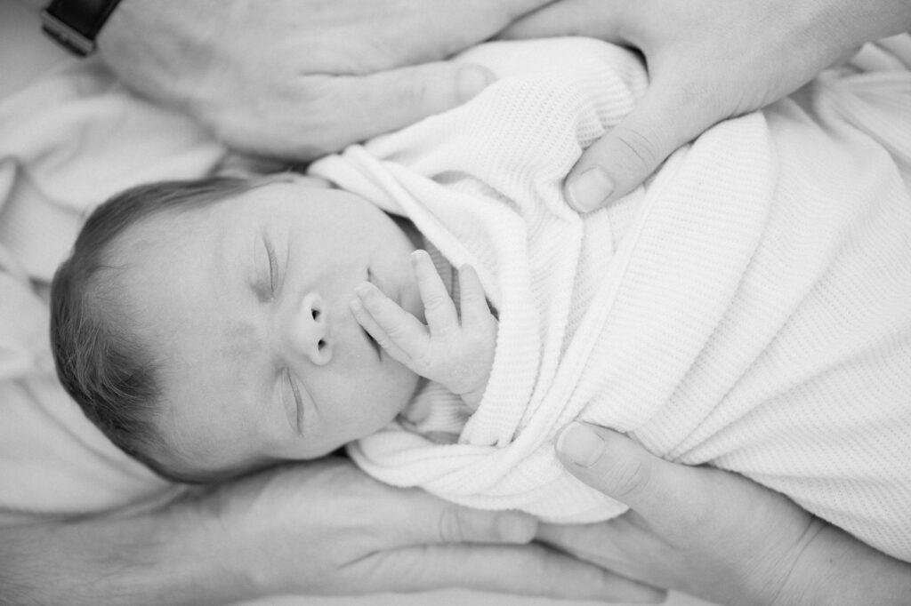 Close-up of a newborn’s hands and feet during a lifestyle studio photography session in Lexington, KY