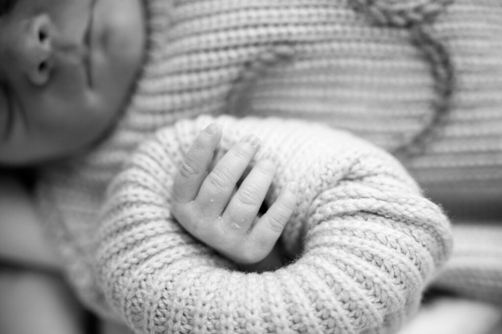 Close-up of a newborn’s hands and feet during a lifestyle studio photography session in Lexington, KY