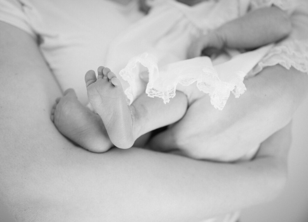 Close-up of a newborn’s hands and feet during a lifestyle studio photography session in Lexington, KY