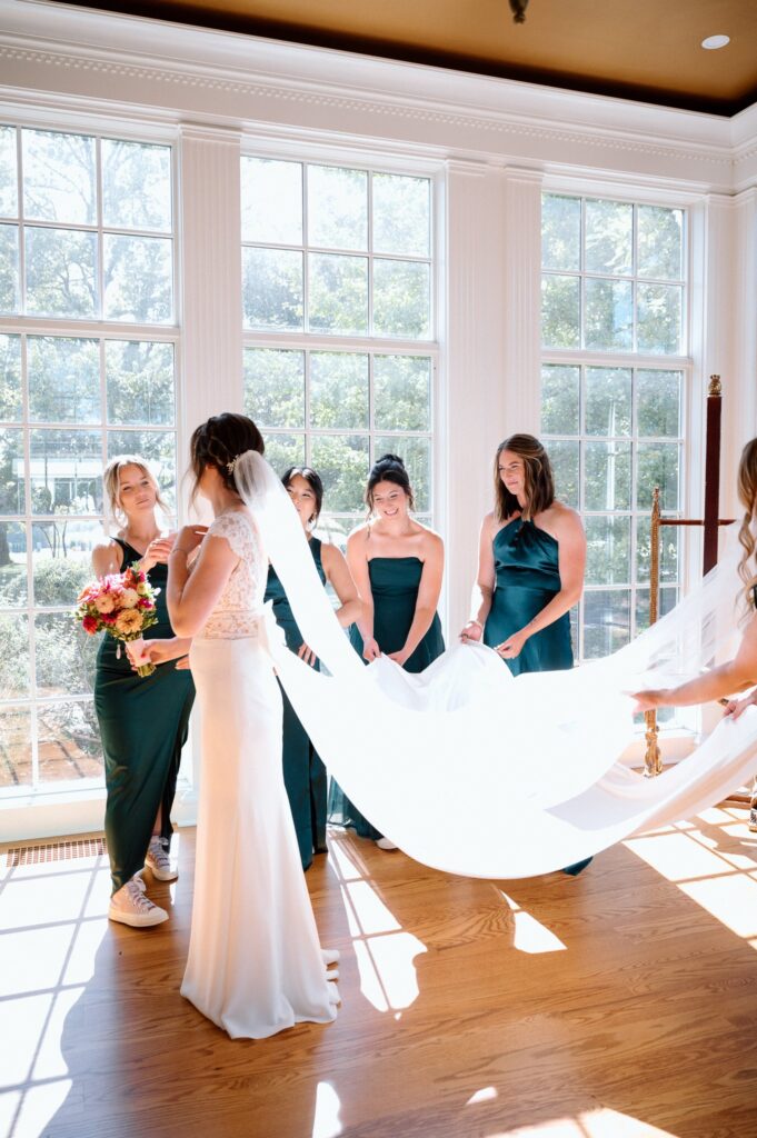 Bride sharing a joyful moment with bridesmaids during wedding preparations