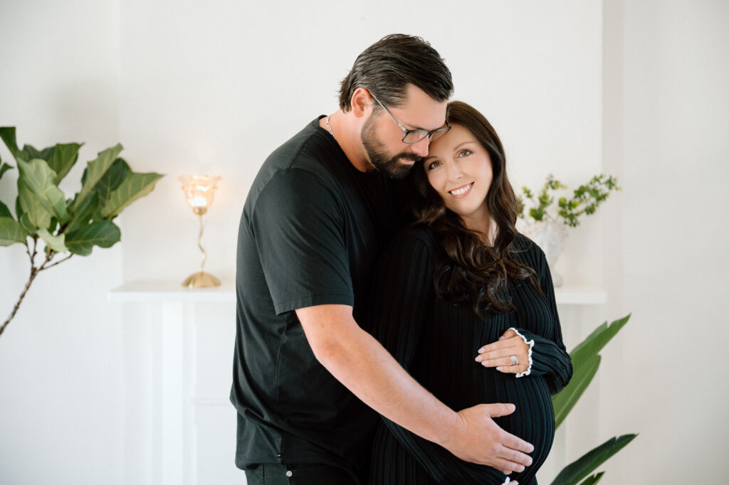 Expecting mom smiling during maternity portraits in downtown Lexington studio