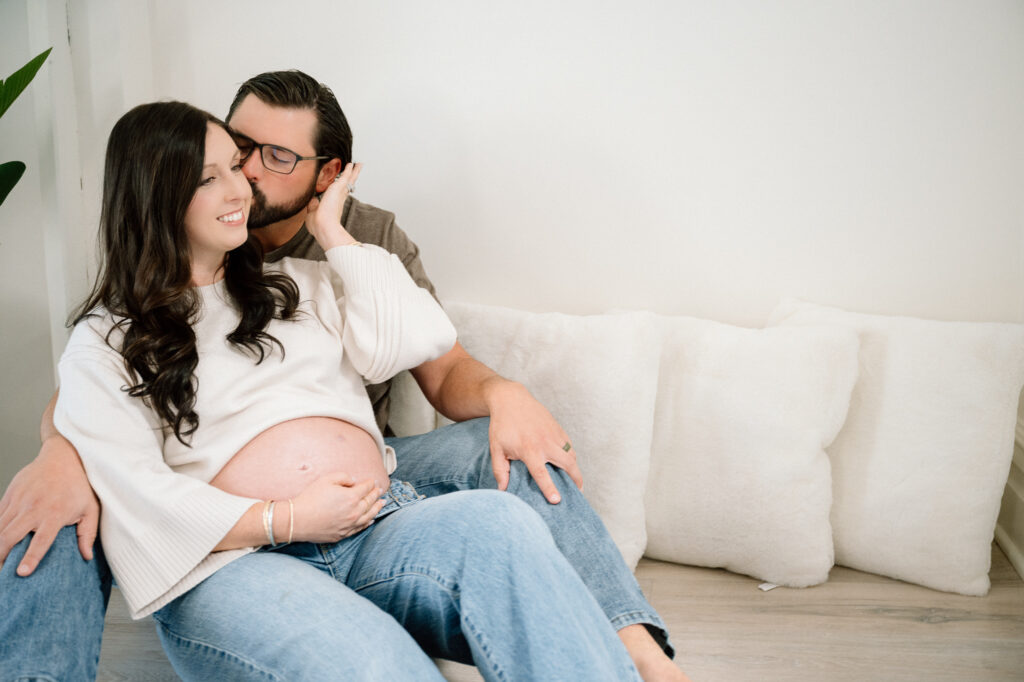 Close-up maternity photo of expecting mom’s hands on baby bump in Lexington studio