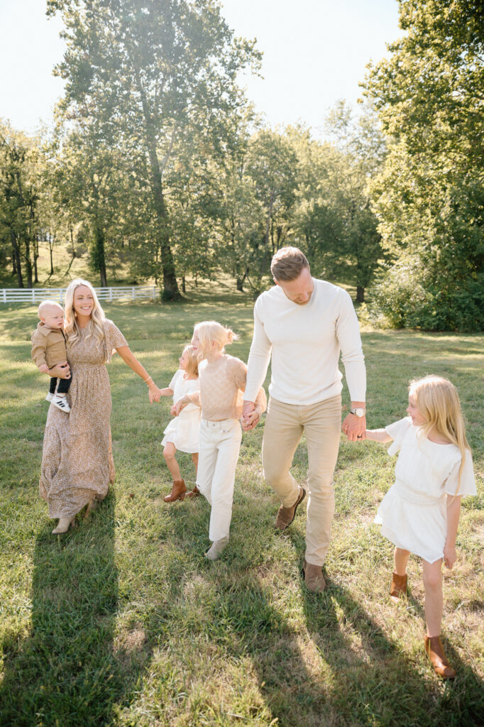Family smiling during 2025 Kentucky fall mini session with warm golden leaves at Keeneland