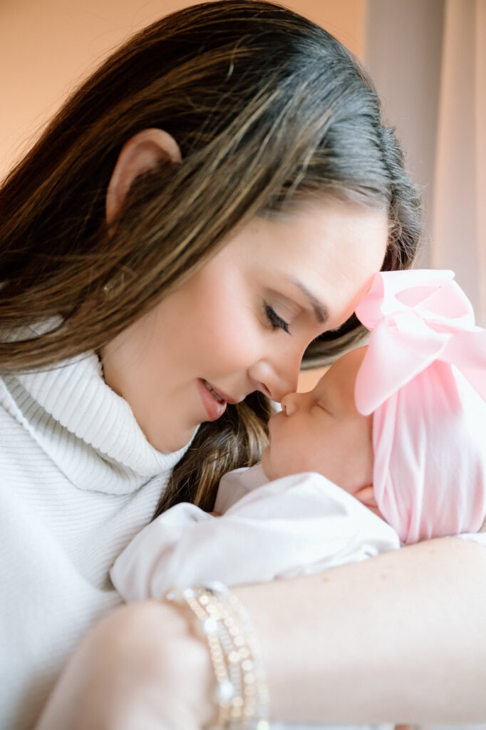 Louisville newborn lifestyle session with parents holding baby in natural window light.