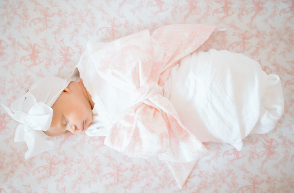 Newborn swaddled in neutral blanket during in-home Louisville lifestyle session.