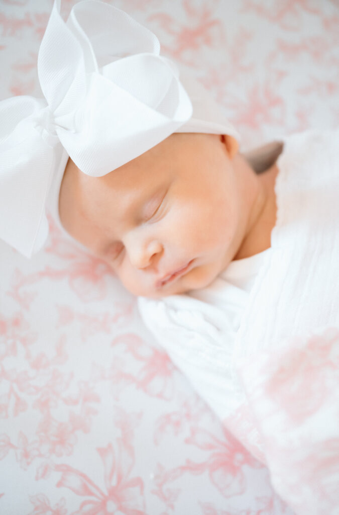 Newborn swaddled in neutral blanket during in-home Louisville lifestyle session.