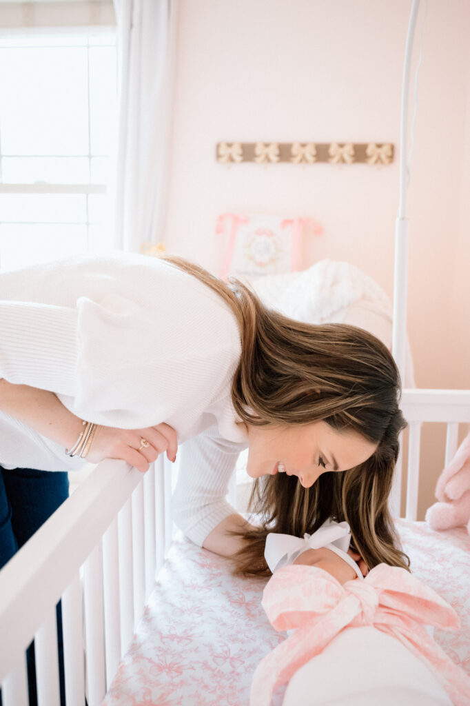 with parents holding baby in natural window light.