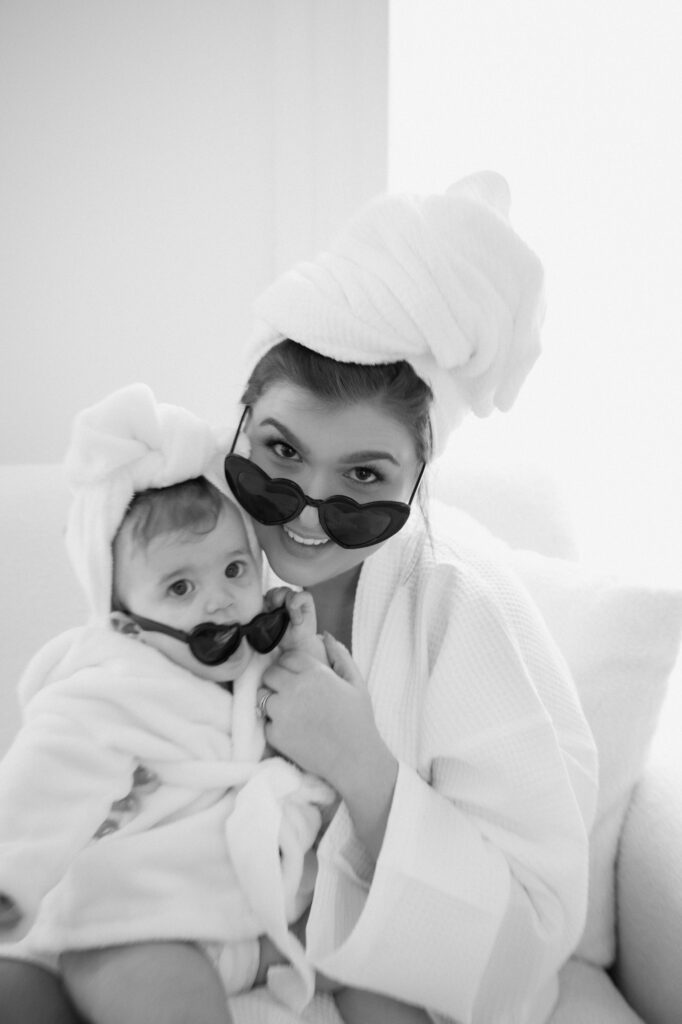 close up of mom holding one year old daughter in cozy bathrobes
