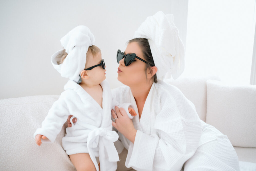 mom and one year old in matching bathrobes during studio photo shoot