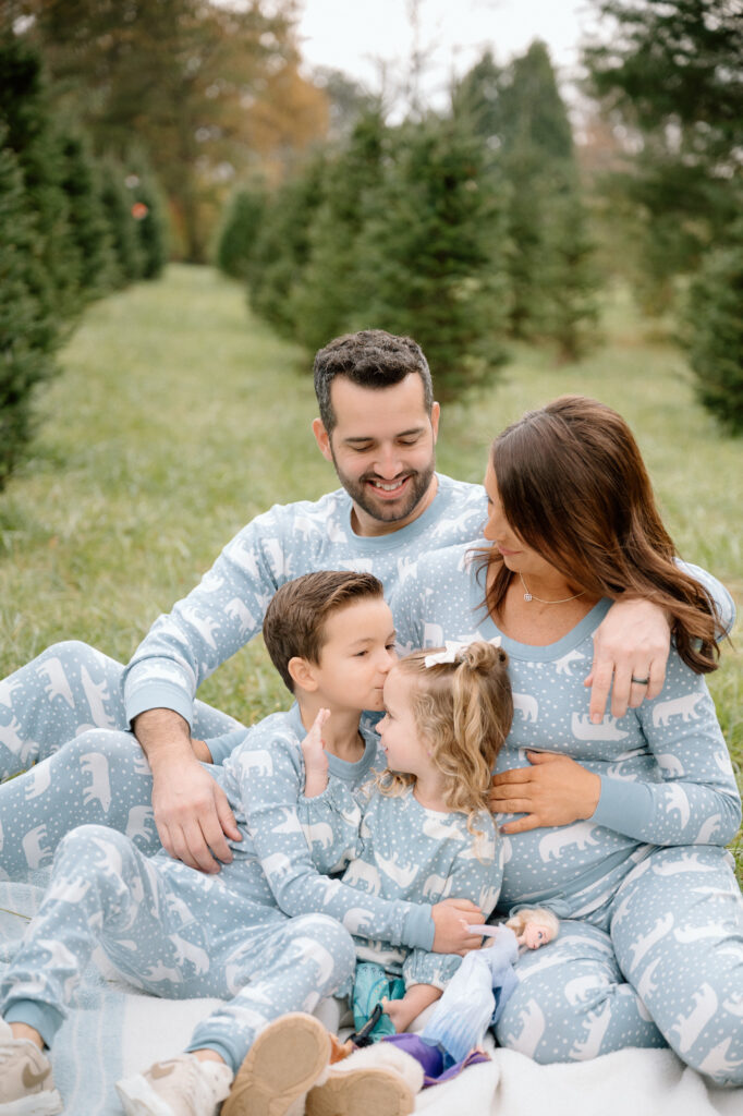 close up of family cuddling during tree farm photo session